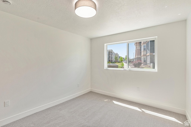 116 E Resaca Unit F3, Midvale, UT 84070 - unfurnished room featuring light colored carpet, baseboards, a textured ceiling, and a smoke detector