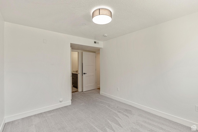 116 E Resaca Unit F3, Midvale, UT 84070 - spare room featuring baseboards, light colored carpet, a textured ceiling, and a smoke detector