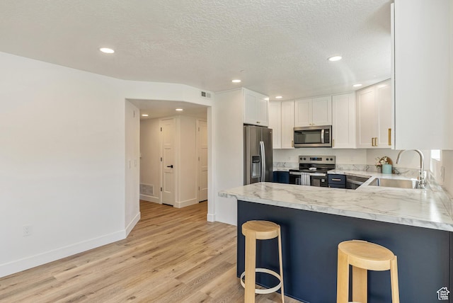116 E Resaca Unit F3, Midvale, UT 84070 - kitchen with stainless steel appliances, a sink, light wood-style floors, white cabinets, and light countertops