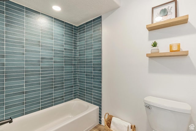 116 E Resaca Unit F3, Midvale, UT 84070 - full bathroom featuring toilet, a textured ceiling, shower / washtub combination, and recessed lighting