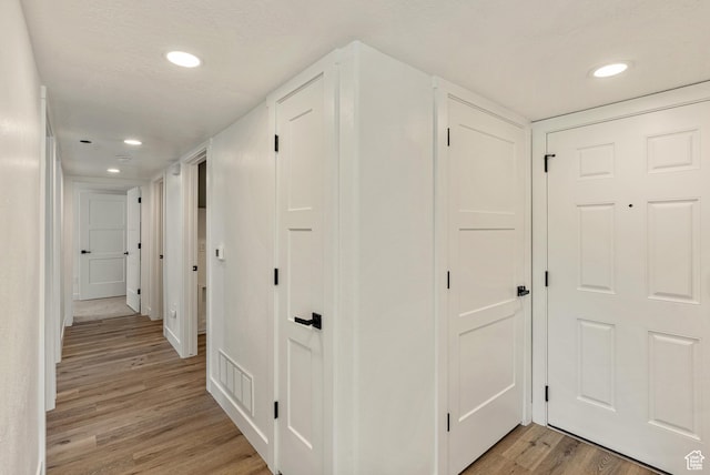 116 E Resaca Unit F3, Midvale, UT 84070 - hall featuring light wood finished floors, recessed lighting, and baseboards