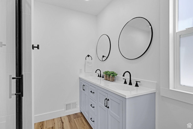 1507 Hudson St, Ogden, UT 84404 - bathroom featuring double vanity, wood finished floors, and baseboards