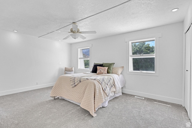 1507 Hudson St, Ogden, UT 84404 - bedroom with multiple windows, baseboards, a ceiling fan, a textured ceiling, and carpet