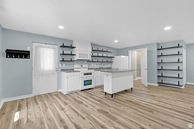 1507 Hudson St, Ogden, UT 84404 - kitchen with open shelves, white appliances, white cabinets, light wood finished floors, and recessed lighting