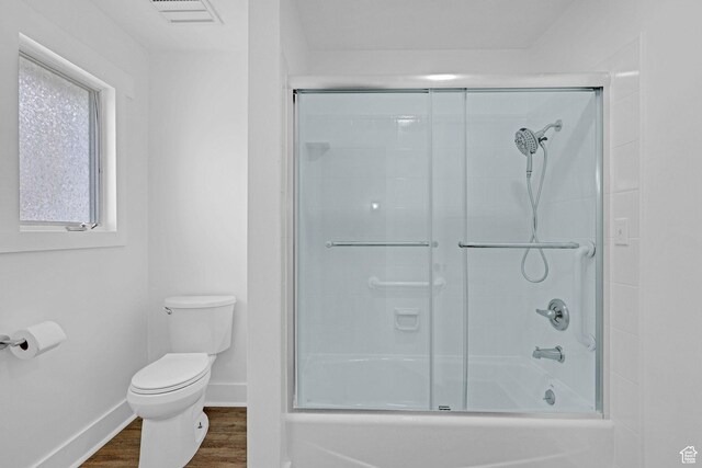 1507 Hudson St, Ogden, UT 84404 - bathroom featuring toilet, baseboards, bath / shower combo with glass door, and wood finished floors