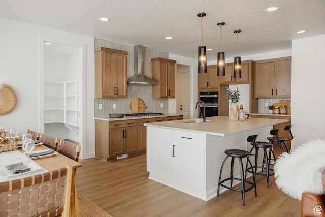 3537 E 1120 S Unit 110, Spanish Fork, UT 84660 - kitchen featuring wall chimney exhaust hood, a sink, backsplash, a breakfast bar area, and recessed lighting