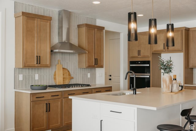 3537 E 1120 S Unit 110, Spanish Fork, UT 84660 - kitchen featuring wall chimney exhaust hood, stainless steel gas cooktop, a sink, backsplash, and light countertops