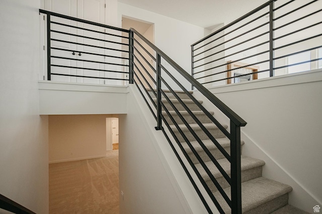 3537 E 1120 S Unit 110, Spanish Fork, UT 84660 - staircase with a towering ceiling, carpet floors, and baseboards