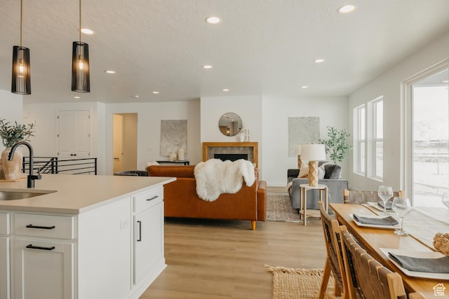 3537 E 1120 S Unit 110, Spanish Fork, UT 84660 - kitchen featuring a sink, recessed lighting, light wood-style floors, white cabinetry, and light countertops