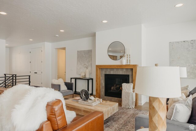 3537 E 1120 S Unit 110, Spanish Fork, UT 84660 - living room featuring recessed lighting, a tile fireplace, and wood finished floors