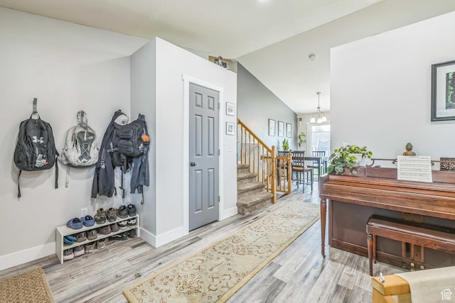 1135 E 220 N, Heber City, UT 84032 - entrance foyer featuring light wood-style flooring, baseboards, lofted ceiling, stairs, and a chandelier