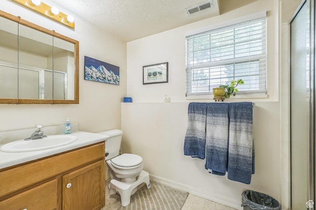 1135 E 220 N, Heber City, UT 84032 - bathroom featuring vanity, toilet, a textured ceiling, a shower with door, and tile patterned flooring