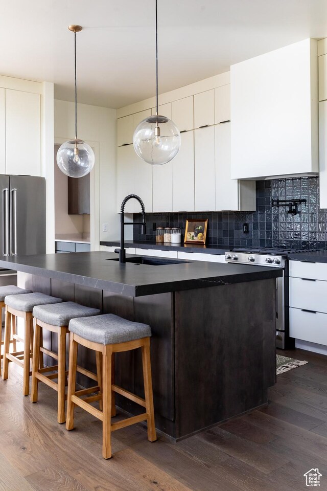 5348 W 10700 N Unit 2, Highland, UT 84003 - kitchen featuring stainless steel appliances, modern cabinets, dark countertops, and dark wood-style floors