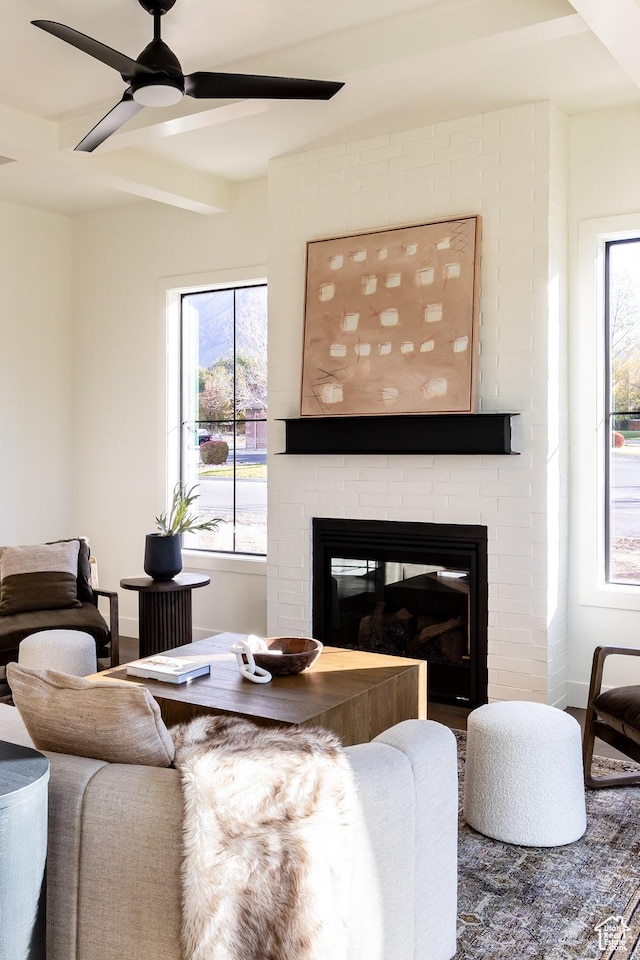 5348 W 10700 N Unit 2, Highland, UT 84003 - living area featuring a brick fireplace, a ceiling fan, and baseboards