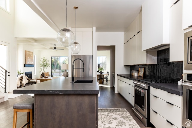 5348 W 10700 N Unit 2, Highland, UT 84003 - kitchen with dark countertops, modern cabinets, a sink, white cabinets, and beamed ceiling