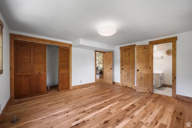 365 Parkview Dr, Summit Park, UT 84098 - unfurnished bedroom with light wood finished floors, baseboards, ensuite bath, and two closets