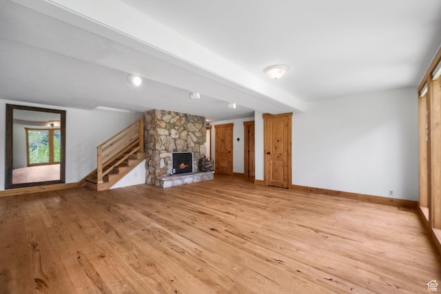 365 Parkview Dr, Summit Park, UT 84098 - unfurnished living room featuring light wood finished floors, a stone fireplace, stairway, and baseboards