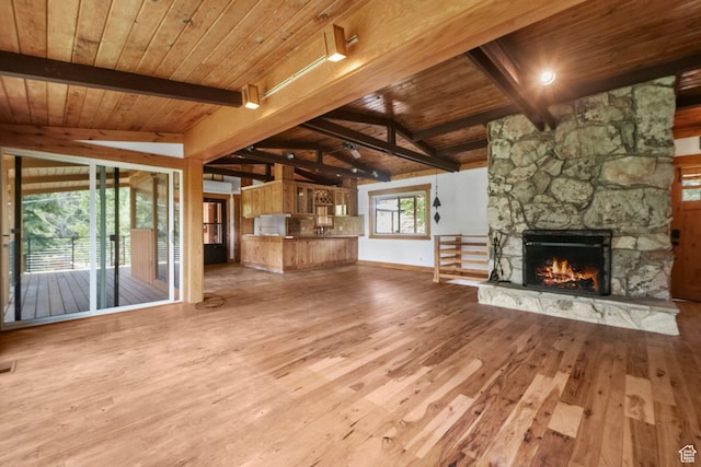 365 Parkview Dr, Summit Park, UT 84098 - unfurnished living room with wood ceiling, wood-type flooring, a stone fireplace, and baseboards