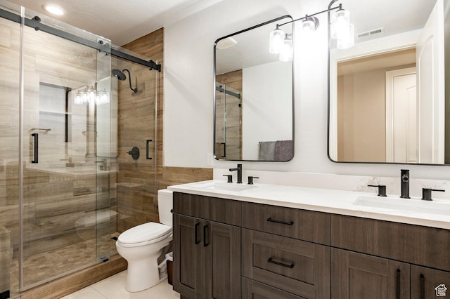 2177 W 9240 S, West Jordan, UT 84088 - full bathroom featuring double vanity, toilet, a shower stall, and tile patterned floors