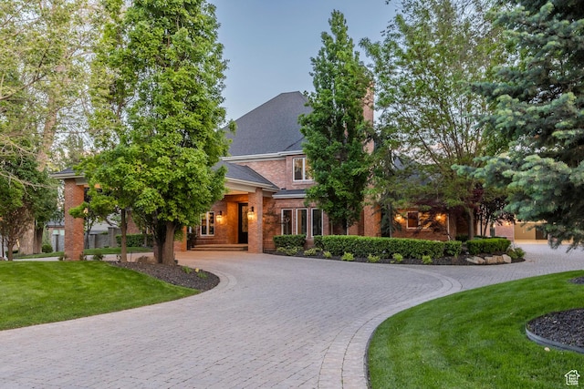 2177 W 9240 S, West Jordan, UT 84088 - view of front of home featuring curved driveway, a front lawn, a chimney, and brick siding