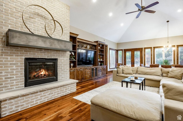 2177 W 9240 S, West Jordan, UT 84088 - living area with high vaulted ceiling, dark wood-type flooring, ceiling fan, a brick fireplace, and recessed lighting