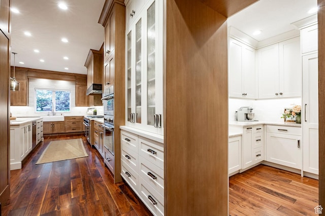 2177 W 9240 S, West Jordan, UT 84088 - kitchen featuring dark wood-style floors, light countertops, decorative backsplash, high end stainless steel range oven, and wall chimney range hood