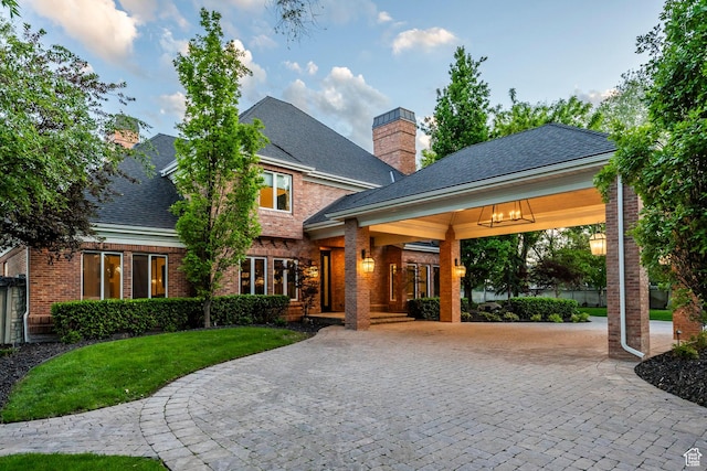 2177 W 9240 S, West Jordan, UT 84088 - view of front of house with curved driveway, brick siding, a front lawn, a chimney, and a shingled roof