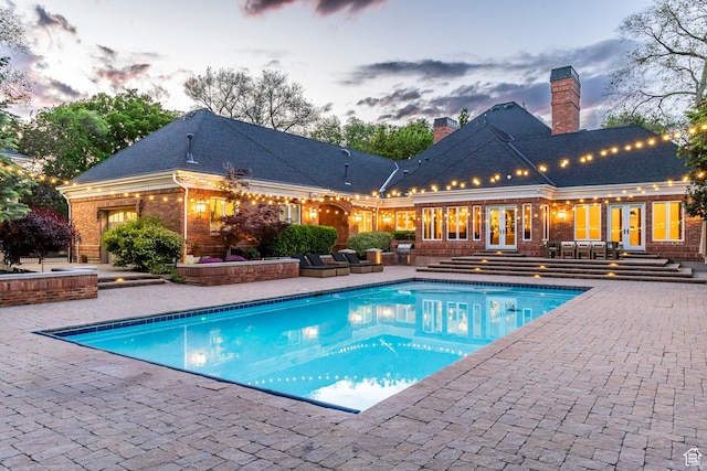 2177 W 9240 S, West Jordan, UT 84088 - pool at dusk with french doors, a patio, an outdoor pool, and entry steps
