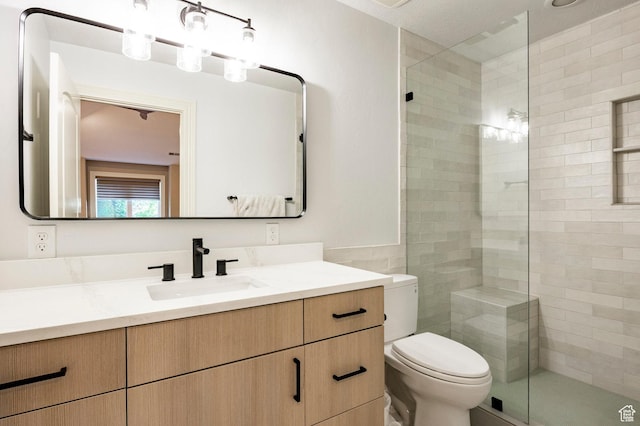 2177 W 9240 S, West Jordan, UT 84088 - full bath with vanity, toilet, a stall shower, tile walls, and wainscoting