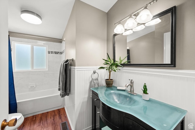 3681 S Terrace Heights Rd, Millcreek, UT 84109 - bathroom with vanity, a wainscoted wall, shower / bath combination with curtain, wood finished floors, and toilet