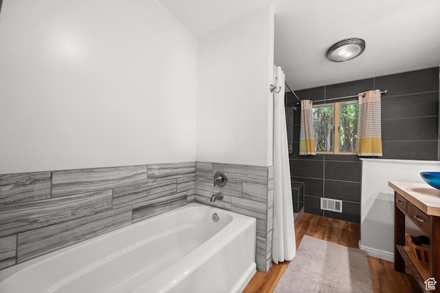 3681 S Terrace Heights Rd, Millcreek, UT 84109 - full bath with vanity, a garden tub, wood finished floors, tile walls, and curtained shower