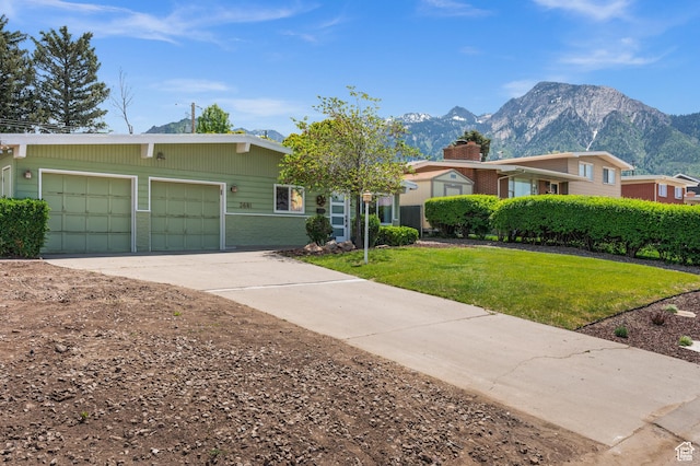 3681 S Terrace Heights Rd, Millcreek, UT 84109 - view of front facade with driveway, a mountain view, a garage, and a front yard