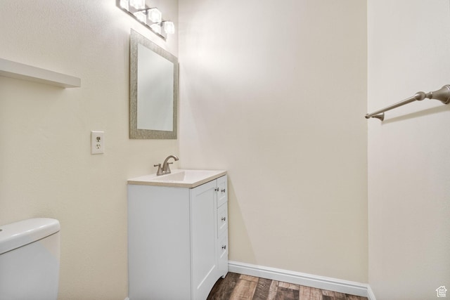 161 E 500 S Unit 11, Provo, UT 84606 - bathroom with vanity, wood finished floors, toilet, and baseboards
