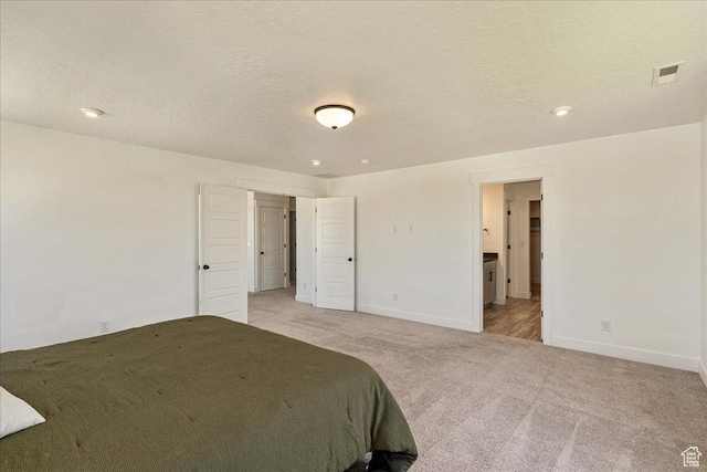 4359 W 200 N, West Point, UT 84015 - bedroom with light colored carpet, baseboards, ensuite bath, a textured ceiling, and recessed lighting