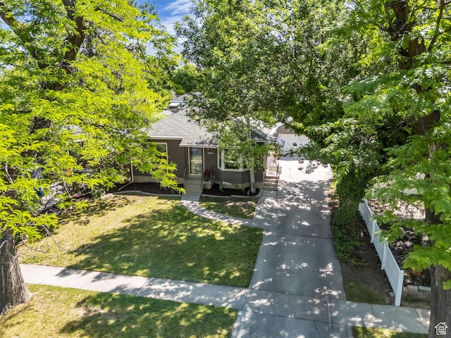 2811 S Filmore St, Salt Lake City, UT 84106 - view of property hidden behind natural elements featuring a shingled roof and a front lawn