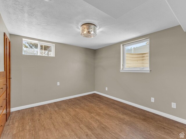 2811 S Filmore St, Salt Lake City, UT 84106 - basement with wood finished floors, baseboards, and a textured ceiling