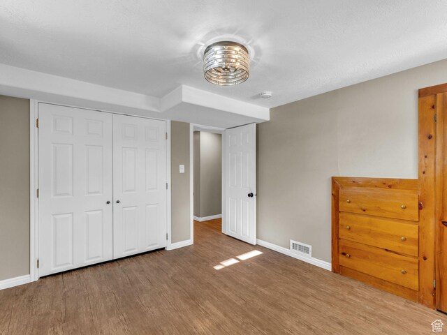 2811 S Filmore St, Salt Lake City, UT 84106 - unfurnished bedroom featuring baseboards, wood finished floors, and a closet