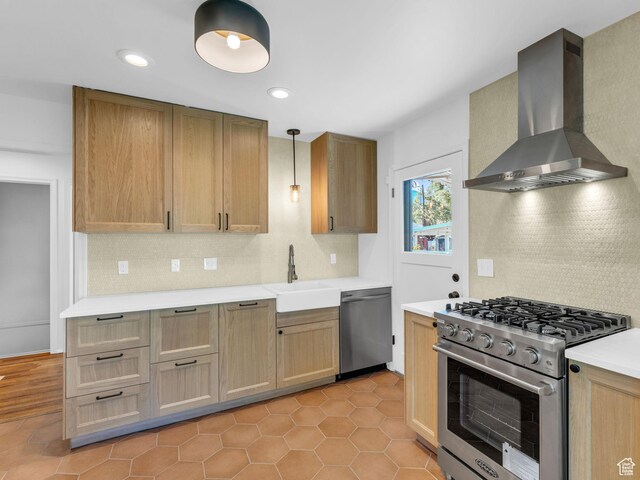 2811 S Filmore St, Salt Lake City, UT 84106 - kitchen with wall chimney range hood, appliances with stainless steel finishes, backsplash, a sink, and light countertops