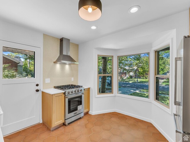 2811 S Filmore St, Salt Lake City, UT 84106 - kitchen with wall chimney range hood, appliances with stainless steel finishes, light countertops, decorative backsplash, and recessed lighting