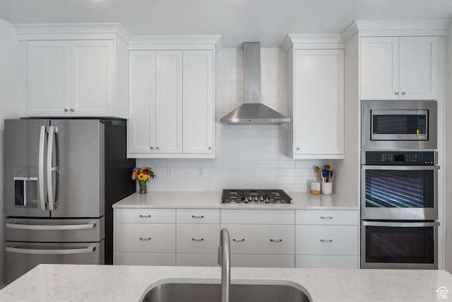 2447 W Santa Fe Dr, Mapleton, UT 84664 - kitchen featuring stainless steel appliances, wall chimney exhaust hood, a sink, white cabinetry, and light stone countertops