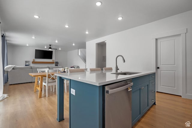 2447 W Santa Fe Dr, Mapleton, UT 84664 - kitchen featuring stainless steel dishwasher, a sink, open floor plan, blue cabinets, and light wood finished floors
