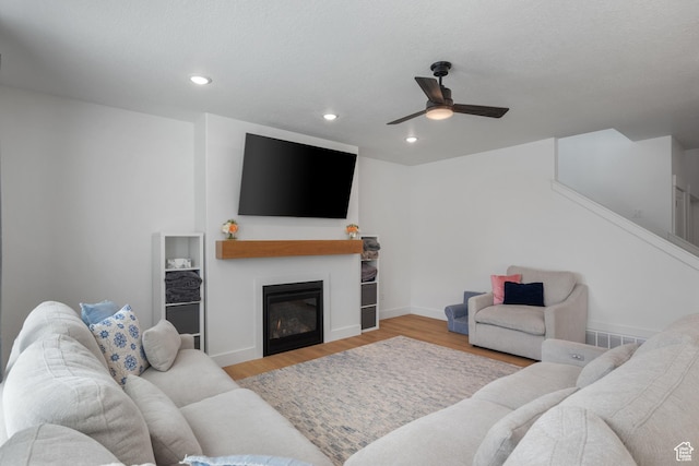 2447 W Santa Fe Dr, Mapleton, UT 84664 - living room with a ceiling fan, wood finished floors, a glass covered fireplace, recessed lighting, and baseboards