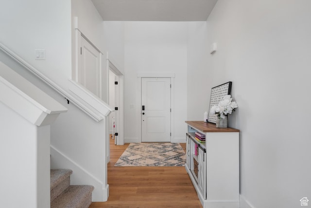 2447 W Santa Fe Dr, Mapleton, UT 84664 - foyer entrance featuring light wood-style flooring, stairway, and baseboards