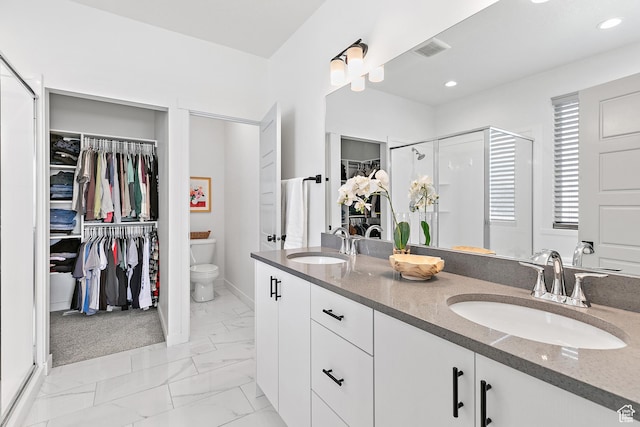 1547 E Cardinal Dr N, Eagle Mountain, UT 84005 - bathroom featuring a walk in closet, double vanity, a shower stall, marble look tiles, and toilet
