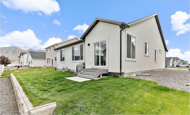 1547 E Cardinal Dr N, Eagle Mountain, UT 84005 - back of house with a yard, stucco siding, and a residential view