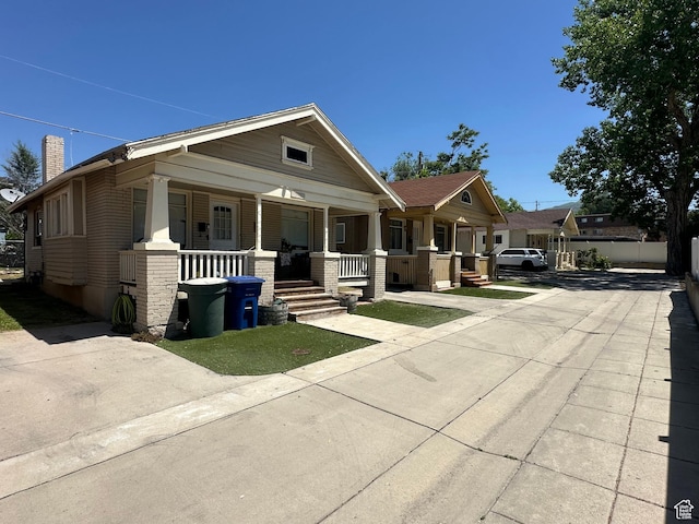 829 E Markea Ave, Salt Lake City, UT 84102 - view of front of house featuring covered porch and a chimney