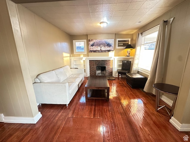 829 E Markea Ave, Salt Lake City, UT 84102 - living room featuring wood-type flooring, a brick fireplace, and baseboards
