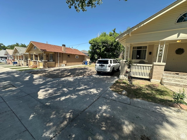 829 E Markea Ave, Salt Lake City, UT 84102 - view of side of property with covered porch, a residential view, and concrete driveway