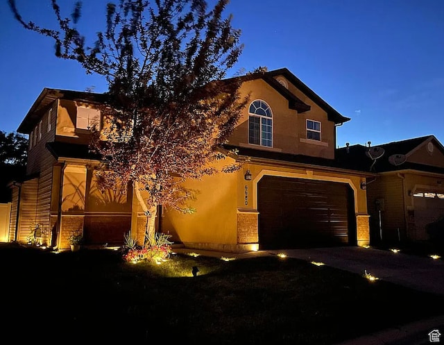 6680 S Leichen Ct, West Jordan, UT 84081 - traditional-style home featuring an attached garage, asphalt driveway, and stucco siding