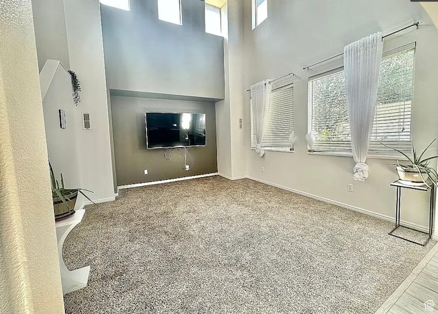 6680 S Leichen Ct, West Jordan, UT 84081 - unfurnished living room with a towering ceiling, plenty of natural light, carpet, and baseboards